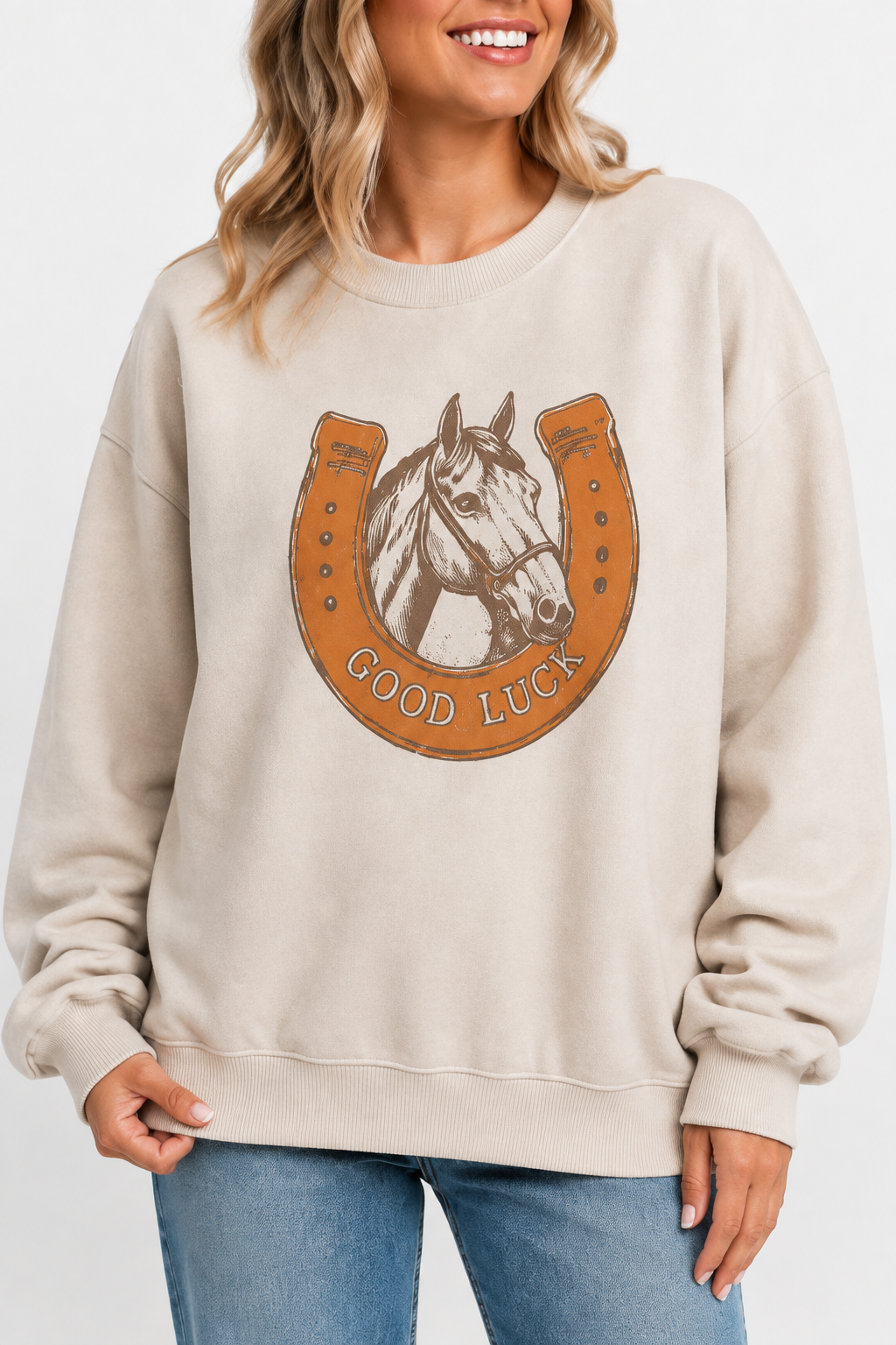 Close-up of beige oversized Western sweatshirt featuring a vintage GOOD LUCK horse and horseshoe graphic.