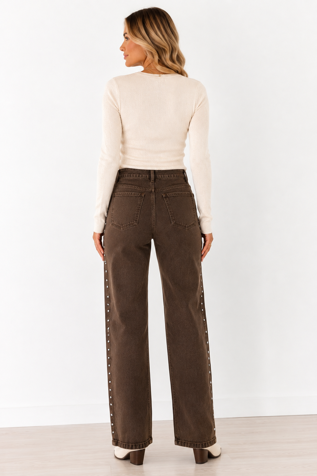 Back view of Emma wearing the coffee brown Saddle Stud Straight-Leg Jeans showing the high waist, back pockets and relaxed straight-leg fit.