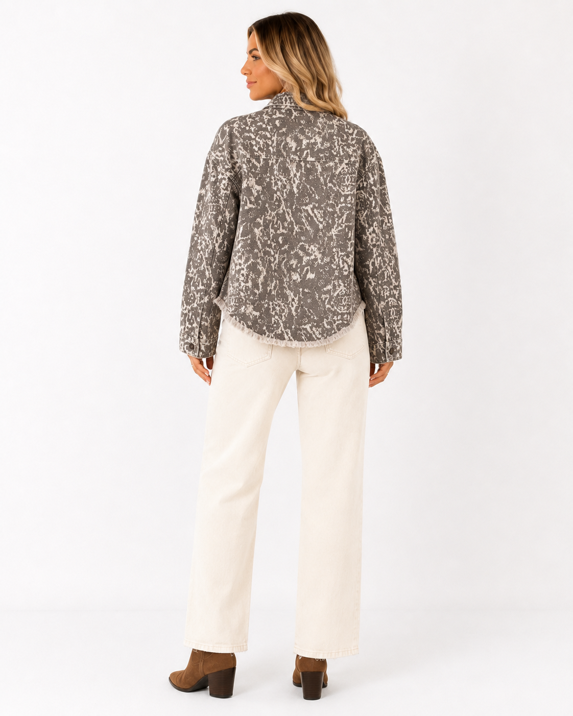 Back view of Emma wearing the Dust & Stone Abstract Denim Jacket with cream jeans, showing the allover abstract print and relaxed fit.