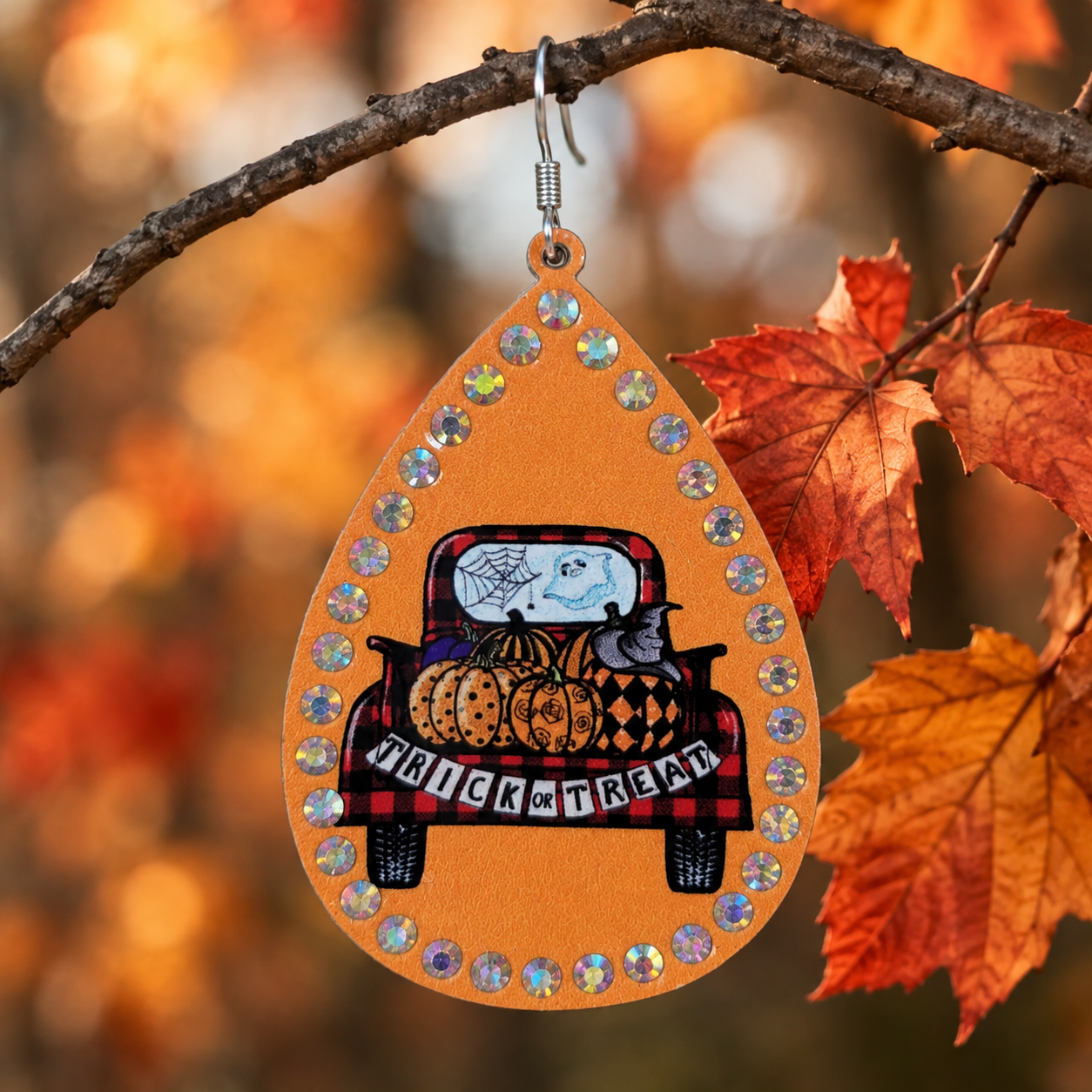 Close-up of Trick or Treat Truck Teardrop Earring with pumpkins, ghost detail and rhinestone border