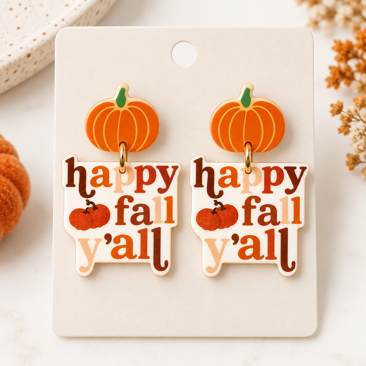 Happy Fall Y’all pumpkin earrings displayed on a neutral jewelry card with seasonal fall styling