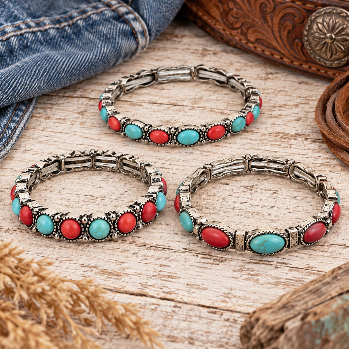 Three western stretch bracelets with faux turquoise-colored and red stones styled with denim and leather