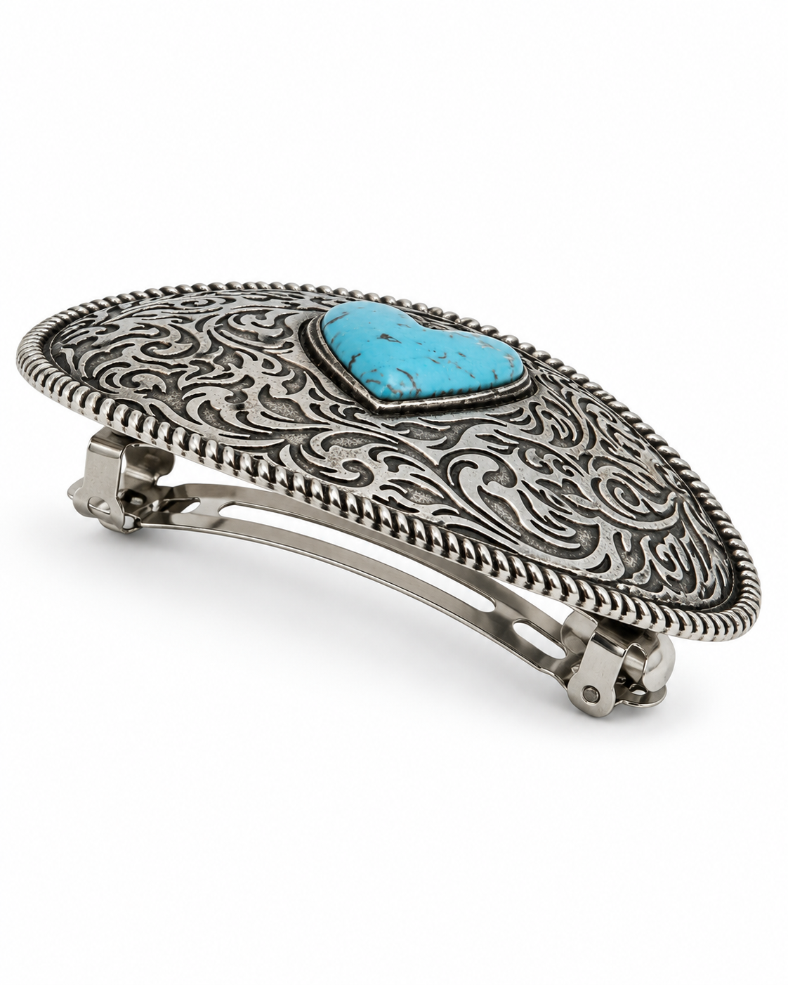A silver-toned concho-style hair clip featuring an engraved scrollwork pattern and a central turquoise heart-shaped stone, shown on a plain white background.