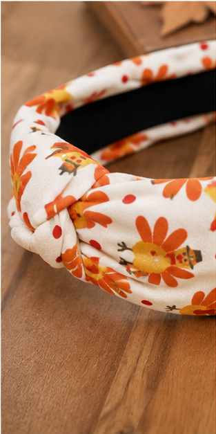 Close-up of ivory turkey print fabric and knotted top detail