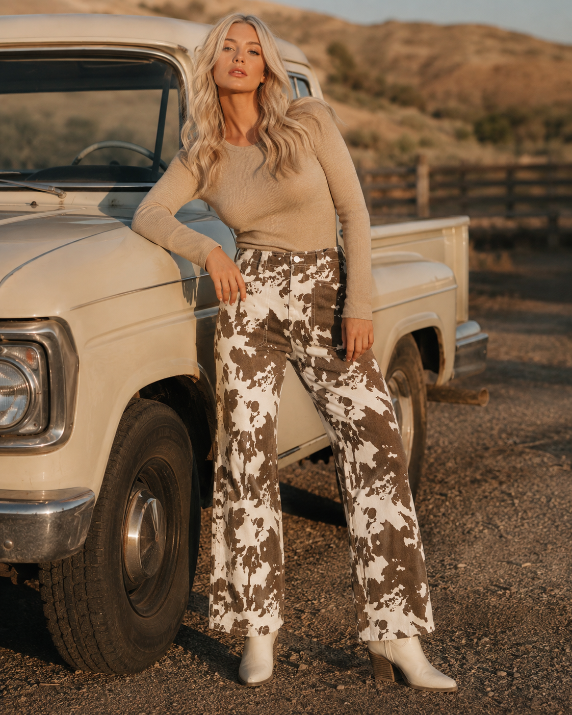 Blonde woman wearing the Painted Mesa Western jeans beside a vintage cream pickup truck