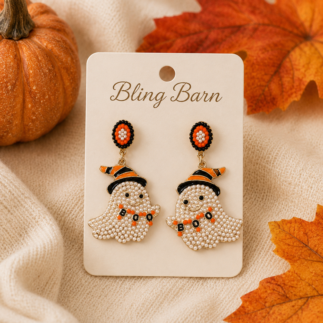 Pearl ghost witch hat earrings styled with pumpkins and fall leaves