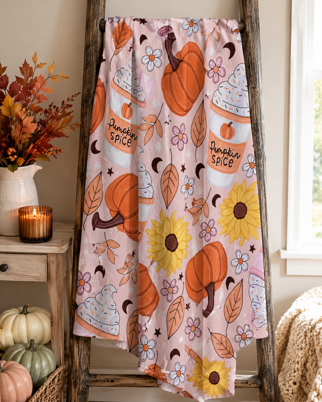 Pumpkin Spice Daydream blanket displayed on a rustic wooden ladder with pumpkins and fall florals
