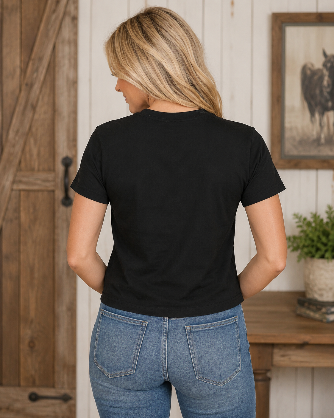 Back view of black Skellington Coffee short sleeve tee on bleach blonde model Emma
