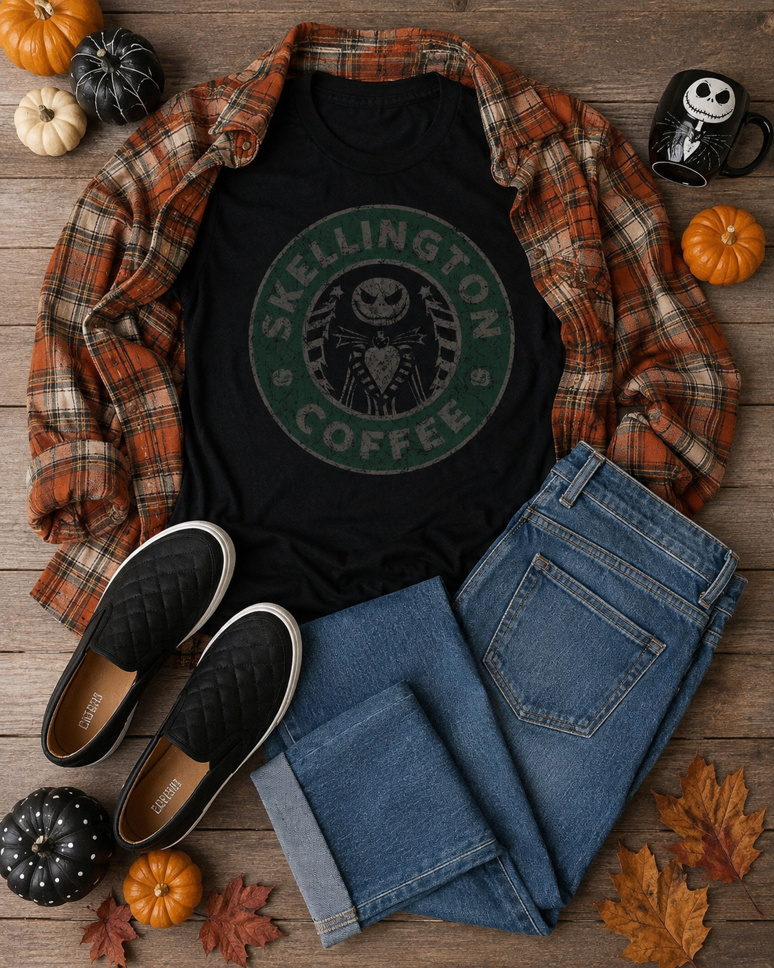 Skellington Coffee fall outfit flat lay with black graphic tee, orange plaid flannel, jeans, black slip-on shoes and pumpkins