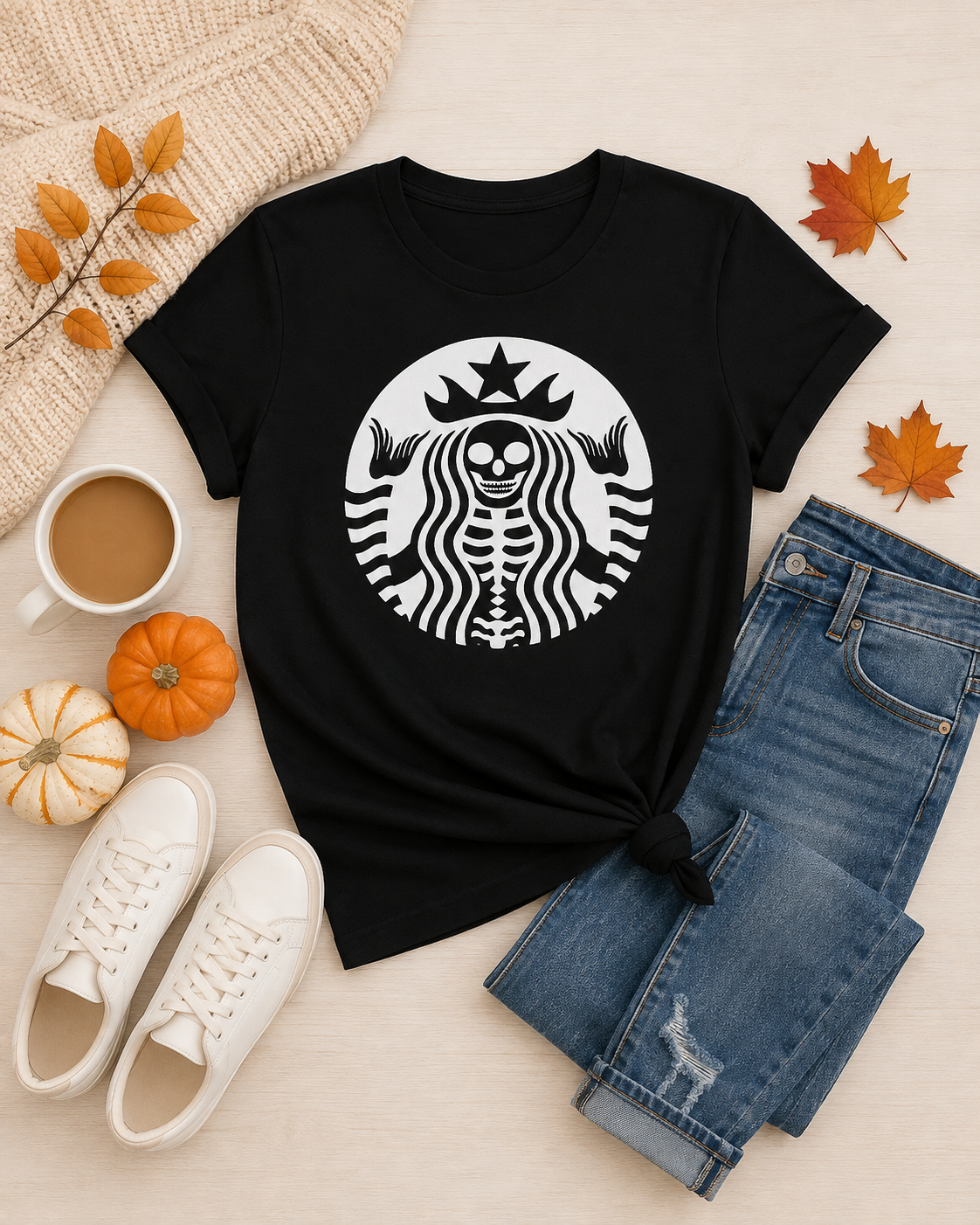 Afterlife Coffee Club Halloween graphic tee flat lay with jeans, white sneakers, coffee, pumpkins and autumn leaves