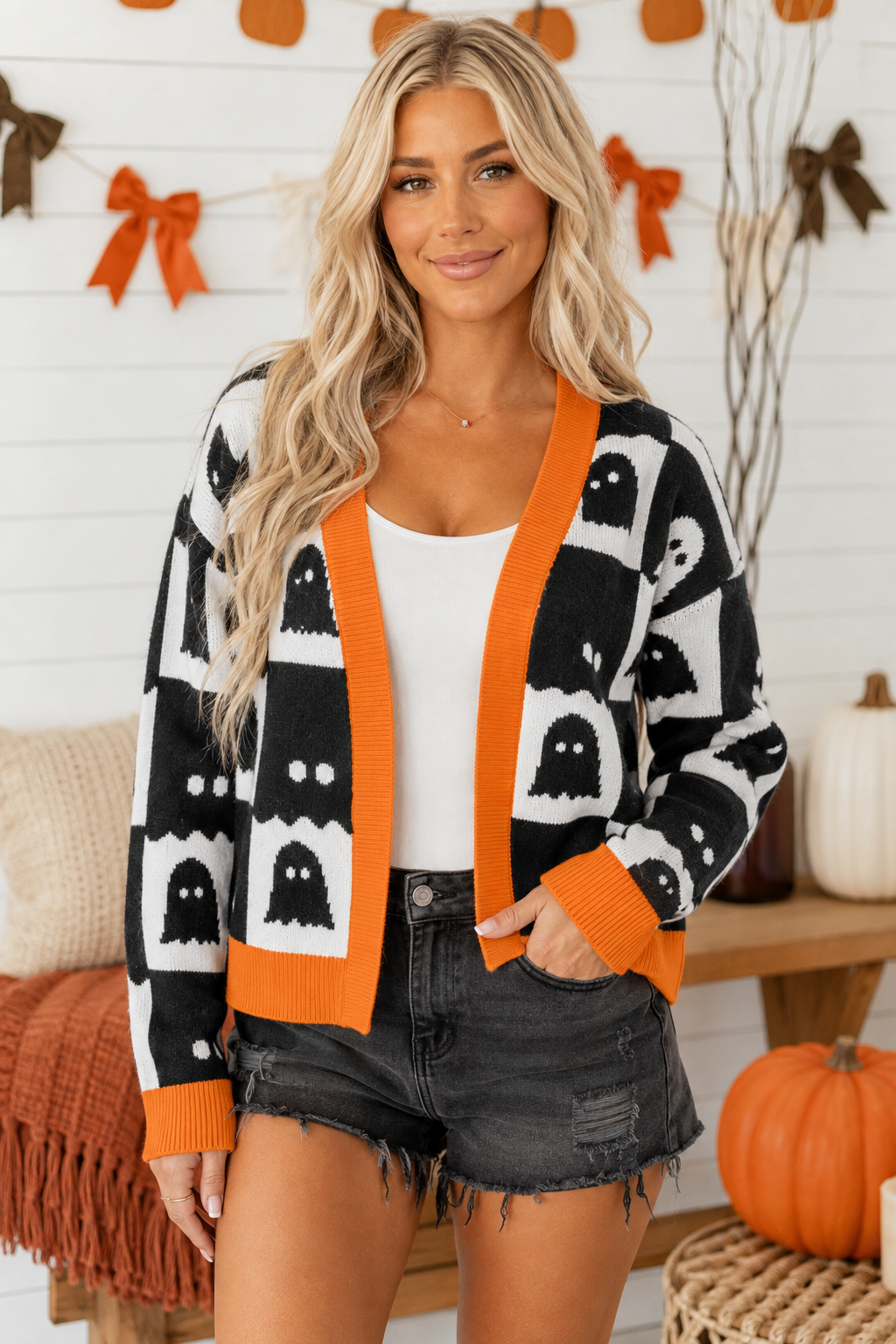 Emma wearing the After Dark Ghost Check Cardigan in a bright styled setting, front view.