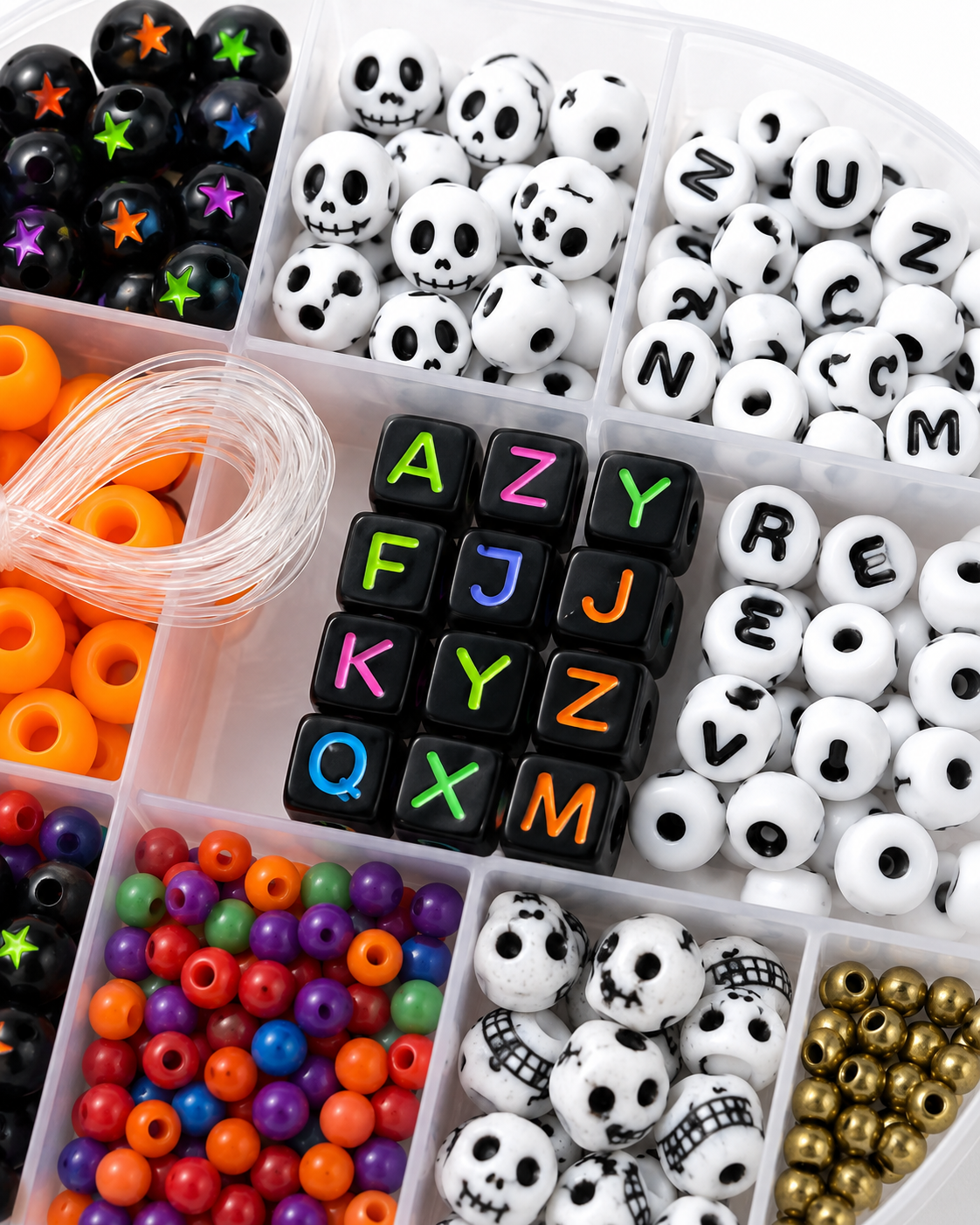 Close-up of Spooky Strings bead assortment featuring skull beads, letter beads, black star beads and colorful accents