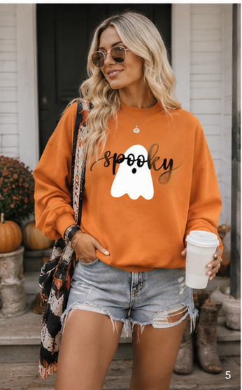 Emma styling the reversible Double the Boo Sweatshirt on a warm fall porch with pumpkins and casual western accessories