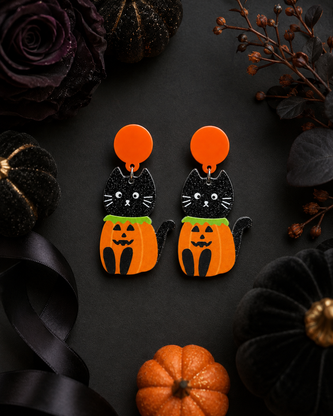 Pumpkin Patch Kitty earrings styled with black ribbon, pumpkins and dark florals for Halloween