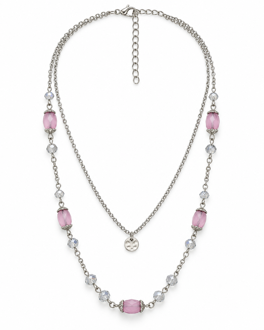 A double-layered silver-tone necklace featuring pink rectangular beads and clear faceted round beads, displayed on a clean white background.