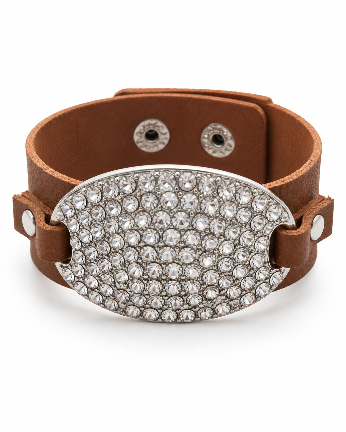 A brown leather cuff bracelet featuring a large, oval-shaped silver-tone plate paved with clear rhinestones, displayed on a clean white background.