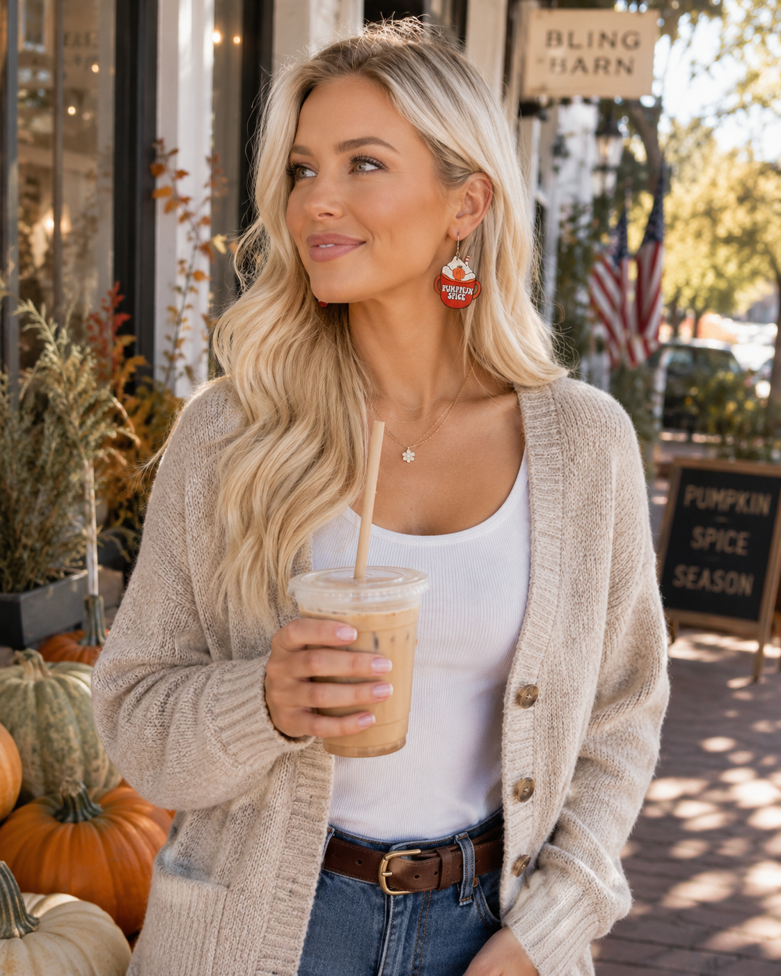 Flat lay of Pumpkin Spice Season Earrings styled beside coffee, gold jewelry, denim and subtle autumn accessories.