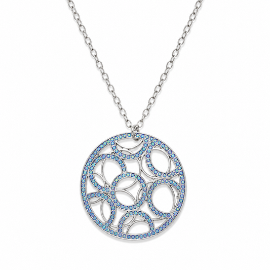 A silver-tone circular pendant necklace featuring an intricate openwork geometric pattern inlaid with small blue stones, suspended from a matching silver chain on a white background.