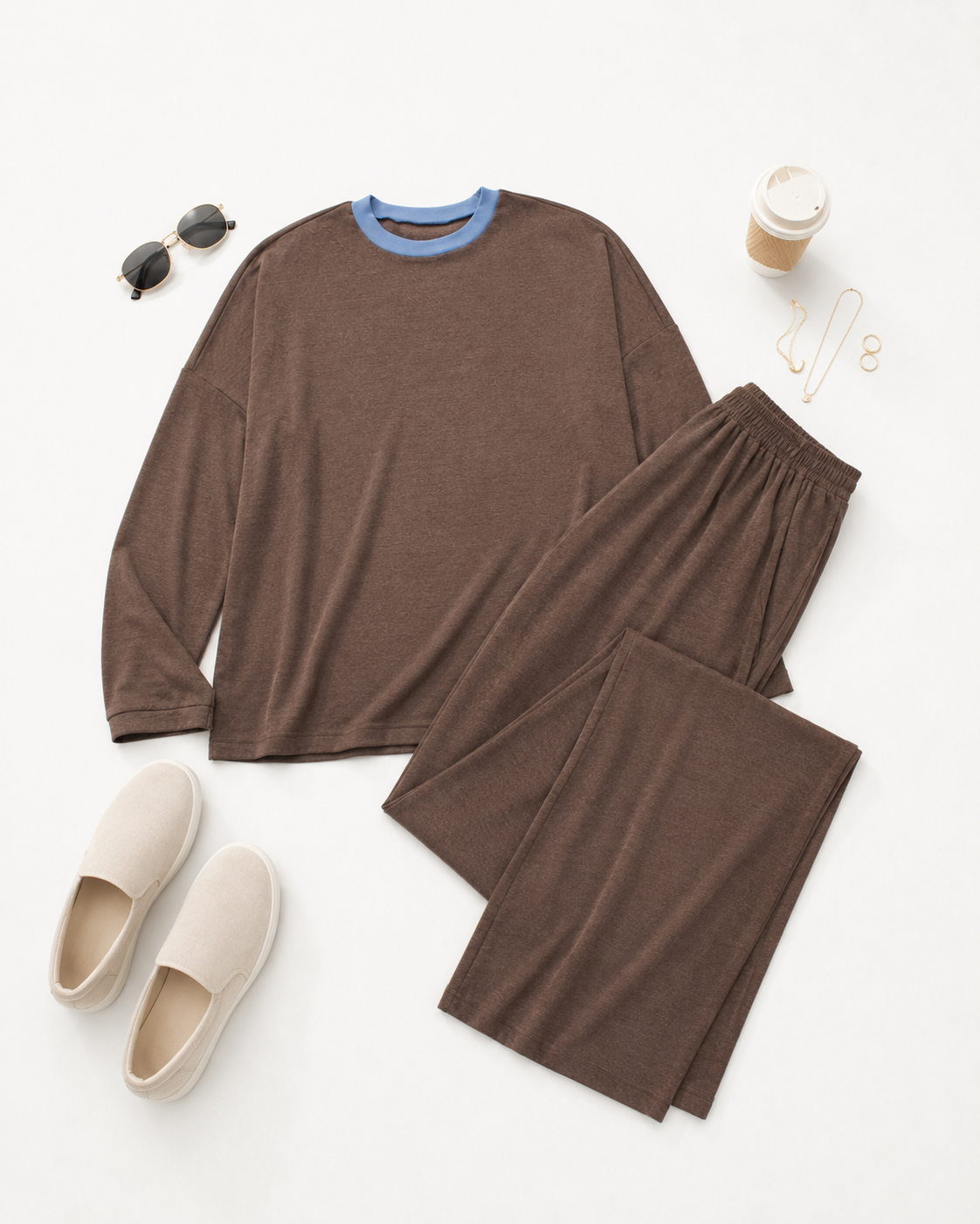 Flat lay of the Mesa Brown Lounge Set with matching wide-leg pants, cream slip-on shoes, sunglasses, coffee cup, and gold jewelry.