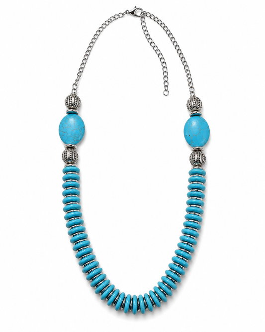 A statement necklace featuring a curved strand of turquoise-colored spacers, a large oval turquoise bead, textured silver spacer beads, and a silver chain extender with clasp, shown on a plain white background.