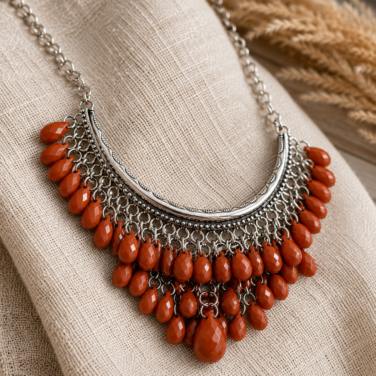 Tight macro shot on soft oatmeal linen or suede. Focus on the antiqued silver-tone metalwork, layered chain texture, and the faceted burnt-rust beads. This one should really show the finish and depth.
