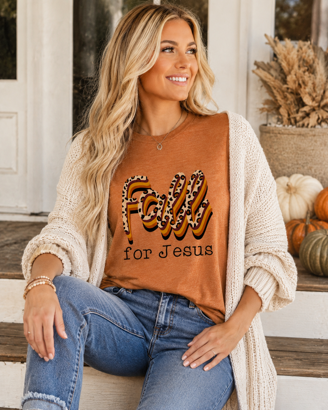 Oatmeal cardigan worn open over the tee with faded jeans.