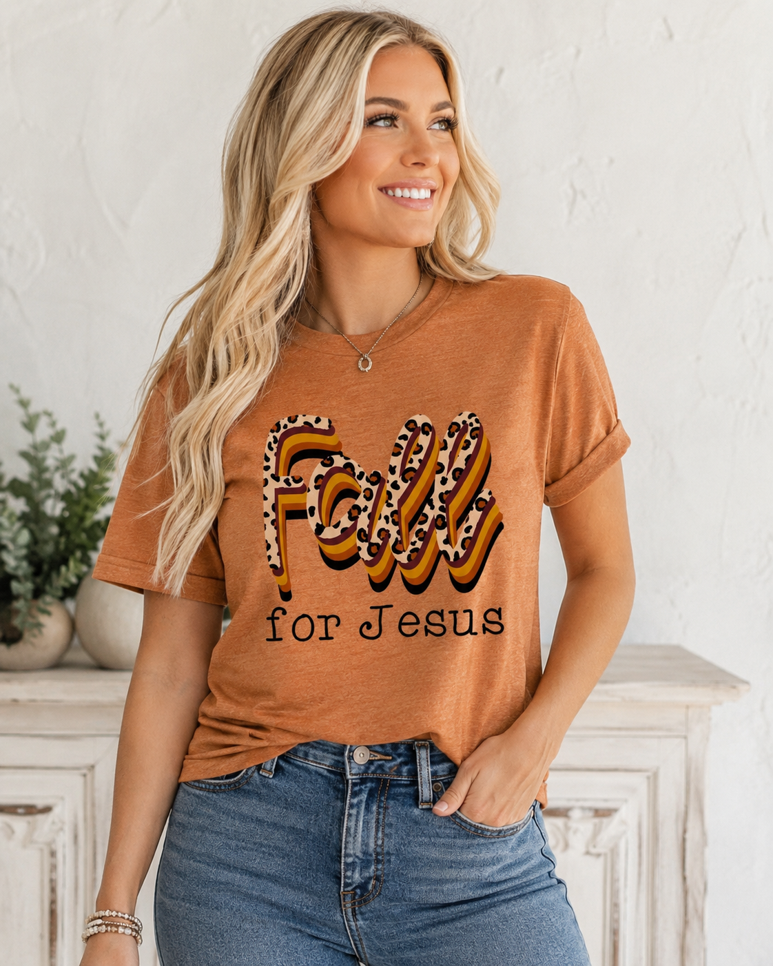 Emma wearing the tee with medium-wash denim, cognac belt and simple jewelry.
