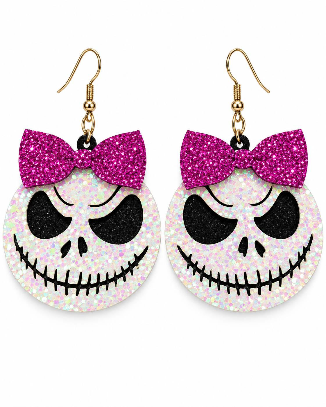 A pair of dangling earrings shaped like Jack Skellington's face, featuring a glittery pink bow on a white glittery circular face with black facial details and gold fishhook wires.