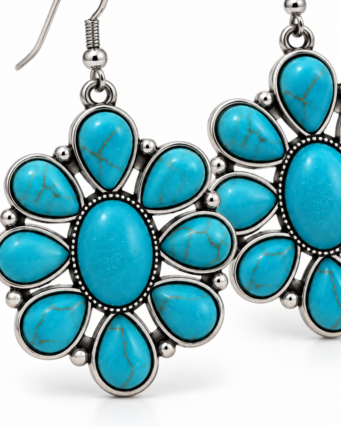 Close-up of a pair of silver-tone dangle earrings with turquoise-blue stone clusters, photographed on a clean white background.