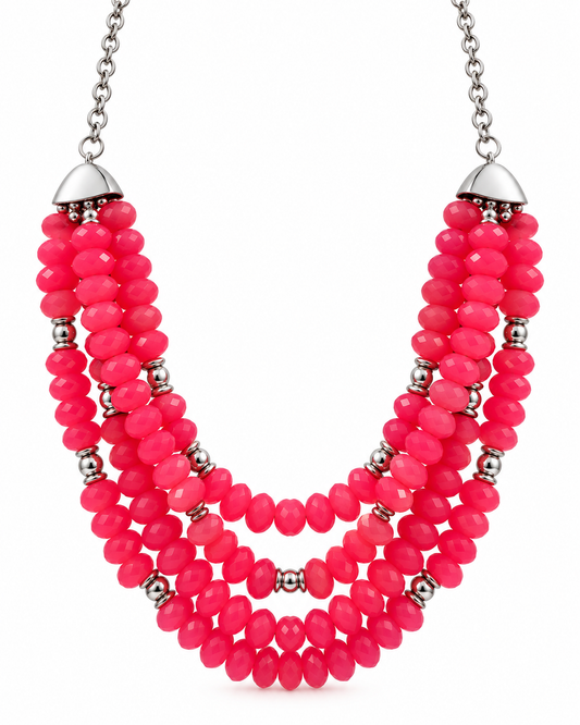 A multi-strand statement necklace featuring vibrant hot pink faceted beads and small metallic silver spacer beads, with silver dome caps and a silver chain.
