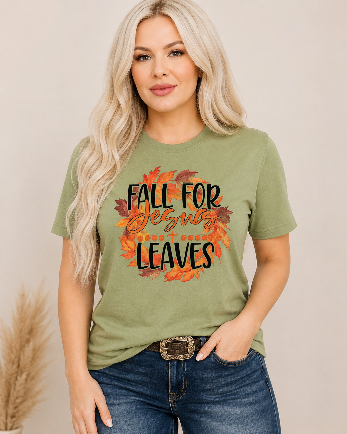 Sage tee, medium-wash denim, cognac belt and subtle turquoise jewelry.