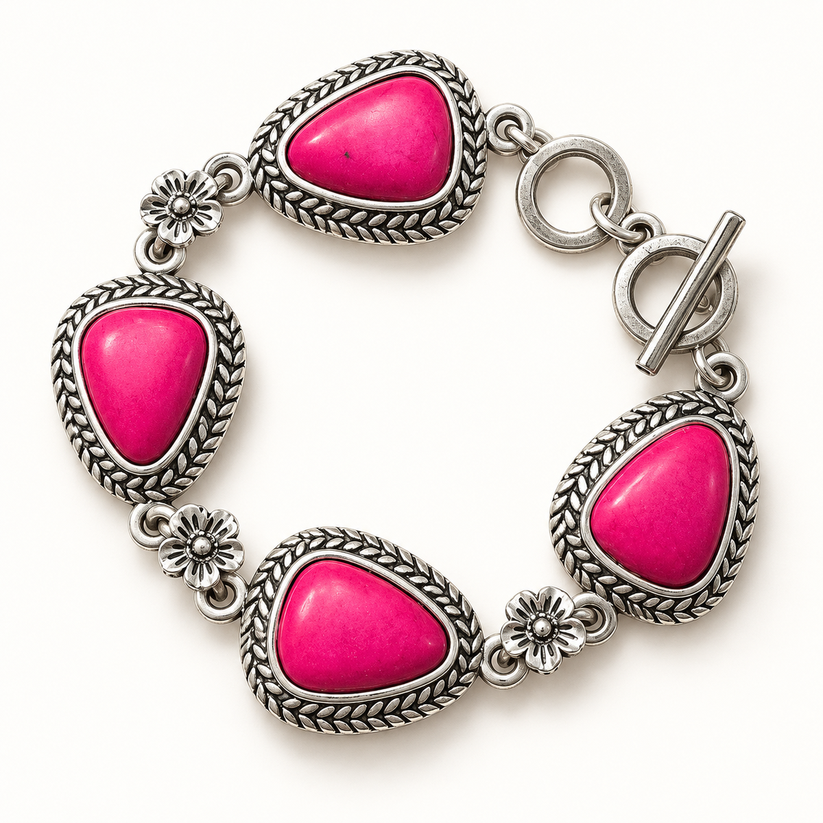 A silver-toned bracelet featuring four bright pink teardrop-shaped cabochon stones, each set in a braided bezel with small floral details, on a white background.