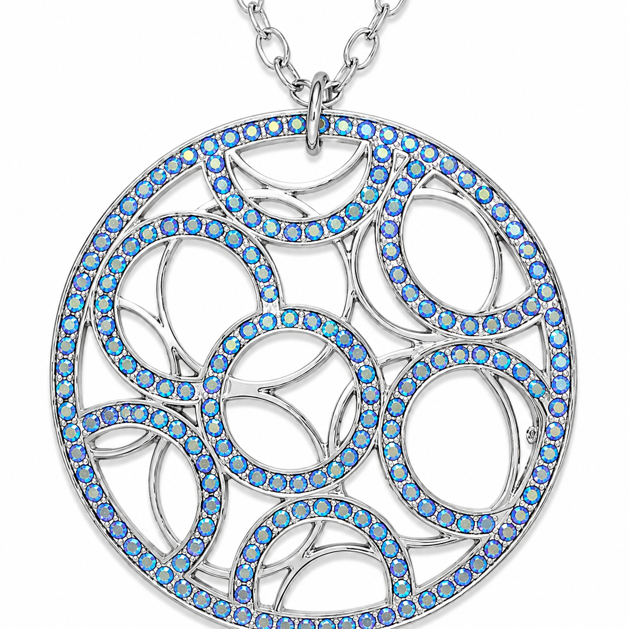 A silver-tone circular pendant necklace featuring intricate cutout patterns outlined with vibrant blue iridescent rhinestones, shown on a clean white background.